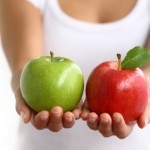 Hands holding red and green apples