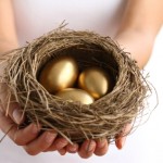 Hands holding nest with golden eggs